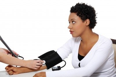 woman checking her BP. https://www.info-on-high-blood-pressure.com